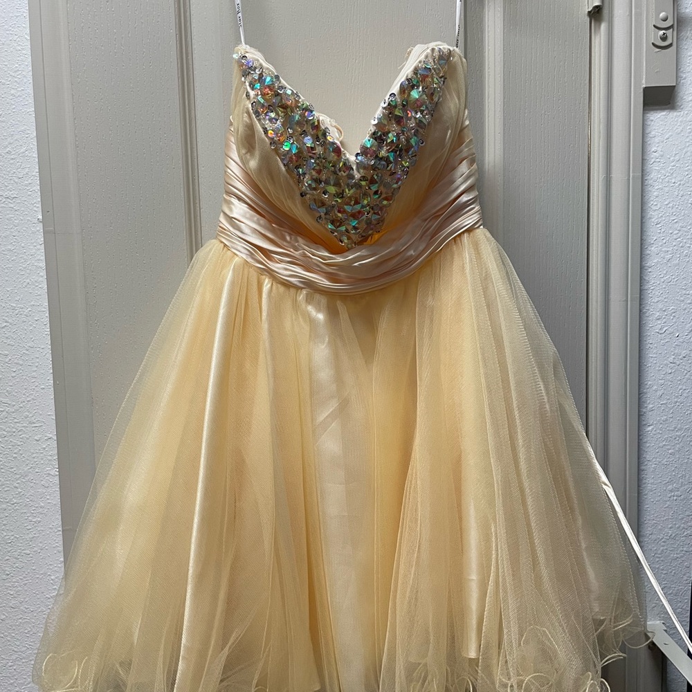Knee length gold formal dress with rhinestones.